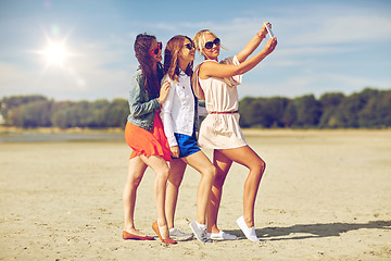 Image showing group of smiling women taking selfie on beach