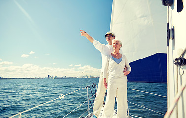 Image showing senior couple sailing on boat or yacht in sea