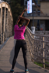 Image showing Black woman doing warming up and stretching