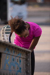 Image showing African American woman doing warming up and stretching