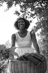 Image showing pretty young african american woman riding a bike in forest