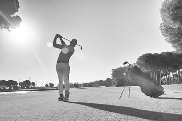 Image showing golf player hitting shot with club