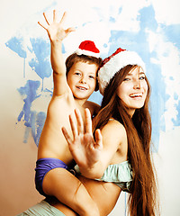 Image showing funny family in red hats celebrating new year, mother with son happy smiling, lifestyle people concept