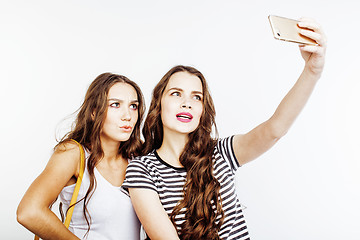 Image showing two best friends teenage girls together having fun, posing emotional on white background, besties happy smiling, making selfie, lifestyle people concept