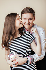 Image showing couple of happy smiling teenagers students, warm colors having a kiss, lifestyle people concept