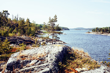 Image showing wild north nature landscape. lot of rocks on lake shore