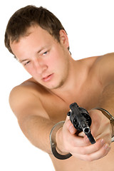 Image showing The young man with a pistol. Focus on pistol. Isolated