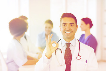 Image showing happy doctor over group of medics at hospital