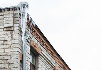 Image showing icicles hanging from building roof and drainpipe