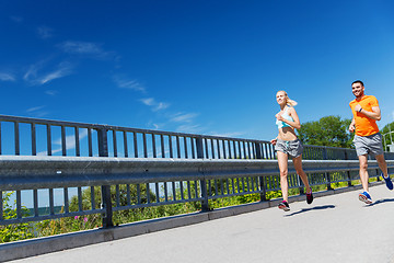 Image showing smiling couple running at summer seaside