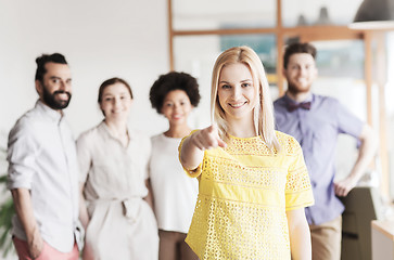 Image showing woman pointing to you over creative office team