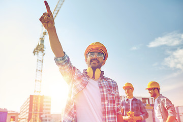 Image showing builders pointing finger aside on construction