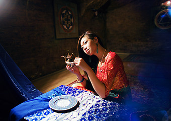 Image showing young pretty asian girl in bright colored interior on carpet vie