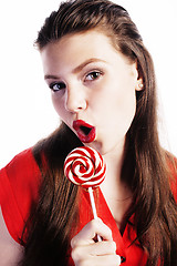 Image showing young pretty brunette girl with red candy posing on white backgr