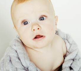 Image showing little cute red head baby in scarf all over him close up isolate