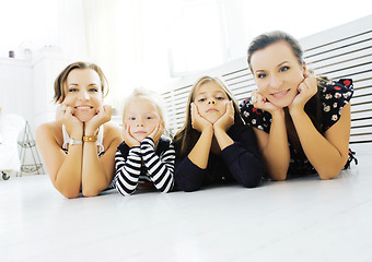 Image showing Mature sisters twins at home with little daughter, happy family 