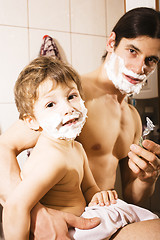 Image showing Portrait of son and father enjoying while shaving together