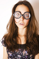 Image showing teenage bookworm concept, cute young woman in glasses, lifestyle