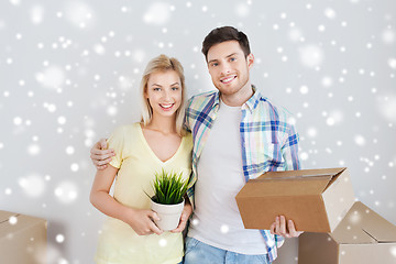 Image showing smiling couple with boxes moving to new home