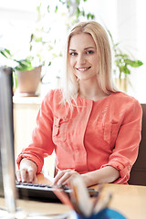 Image showing happy business woman with computer at office