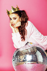 Image showing young cute disco girl on pink background with disco ball and cro