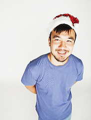 Image showing funy exotical asian Santa claus in new years red hat smiling