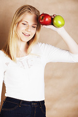 Image showing young pretty blond woman choosing between red and green apple sm