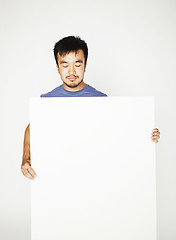 Image showing pretty cool asian man holding empty white plate smiling