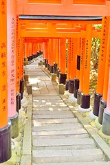 Image showing Red torii gates and stone steps at Fushimi Inari Shrine, Kyoto. Wishes written in Japanese on the posts.