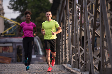 Image showing multiethnic couple jogging in the city