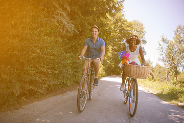 Image showing Young multiethnic couple having a bike ride in nature