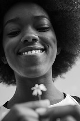 Image showing portrait of African American girl with a flower in her hand