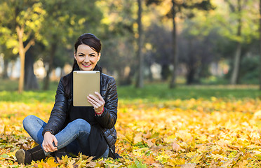 Image showing Woman with a Tablet in a Forest in the Autumn