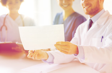 Image showing close up of doctors with cardiogram at hospital 