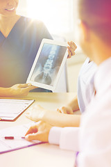 Image showing close up of happy doctors with x-ray at hospital