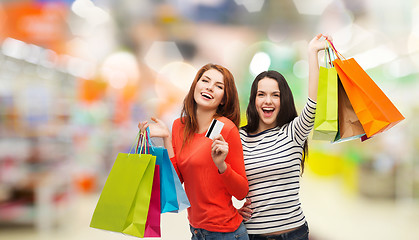 Image showing teenage girls with shopping bags and credit card