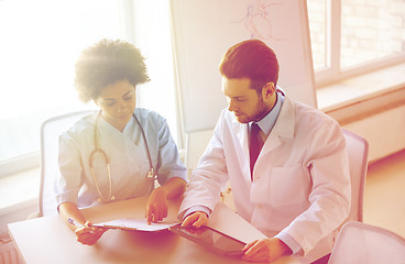 Image showing doctors with tablet pc and clipboard at hospital