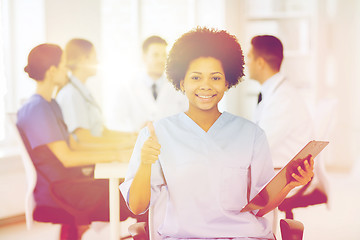 Image showing happy doctor over group of medics at hospital