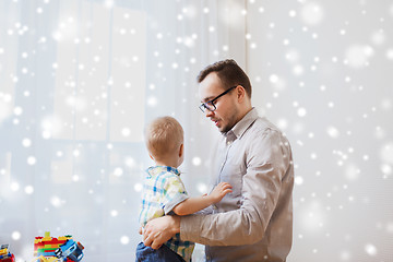 Image showing father taking care of little son at home