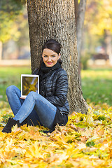 Image showing Woman with a Tablet in a Forest in the Autumn