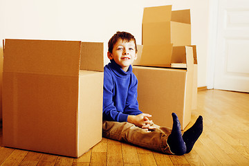 Image showing little cute boy in empty room, remoove to new house. home alone, lifestyle people concept