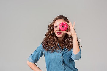 Image showing The smiling girl on gray studio background with round cake