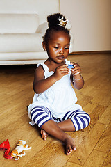 Image showing little cute african american girl playing with animal toys at ho