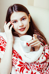 Image showing young pretty brunette girl in Christmas ornament blanket getting warm on cold winter, freshness beauty concept, lifestyle people