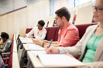 Image showing group of students with notebooks in lecture hall