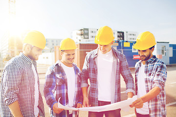 Image showing group of builders with tablet pc and blueprint