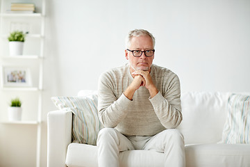 Image showing close up of senior man in glasses thinking