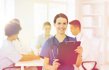 Image showing happy doctor over group of medics at hospital