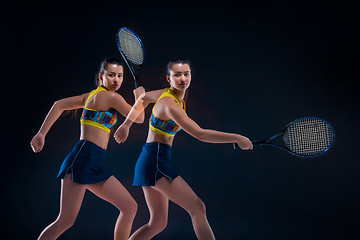 Image showing Portrait of beautiful girl tennis player with a racket on dark background