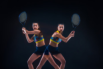 Image showing Portrait of beautiful girl tennis player with a racket on dark background